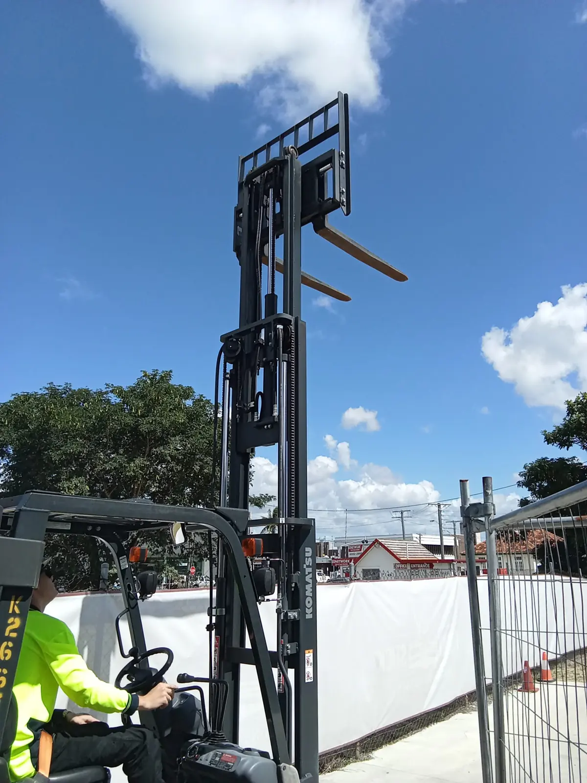 A Forky Stick trainee operating a Komatsu forklift with the mast raised at the Rockhampton training yard